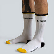 SOCKENREBELL white crew socks with black and yellow accents, featuring the "ALEMANNIA" logo. Made from cotton blend.