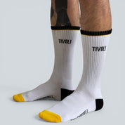 SOCKENREBELL white crew socks with black and yellow accents and TIVOLI logo. Made from cotton blend.