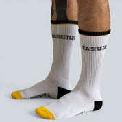 SOCKENREBELL white crew socks with black and yellow accents, featuring "KAISERSTADT" text.