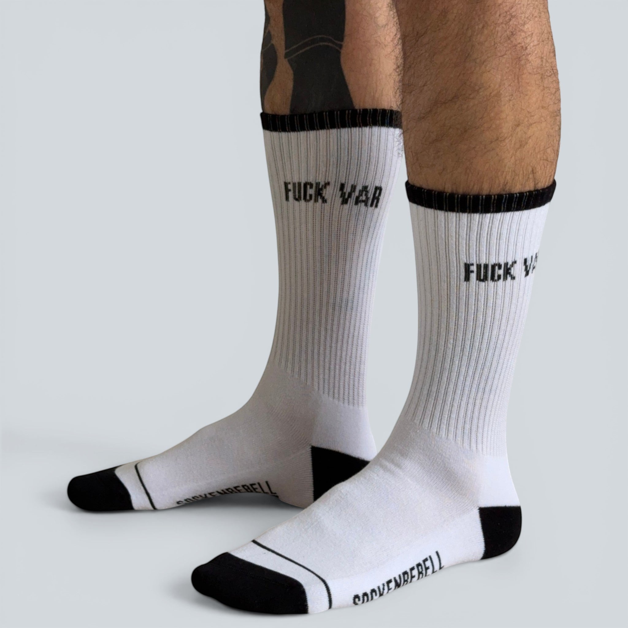 SOCKENREBELL white crew socks with black trim and "FUCK VAR" text, made of cotton blend.
